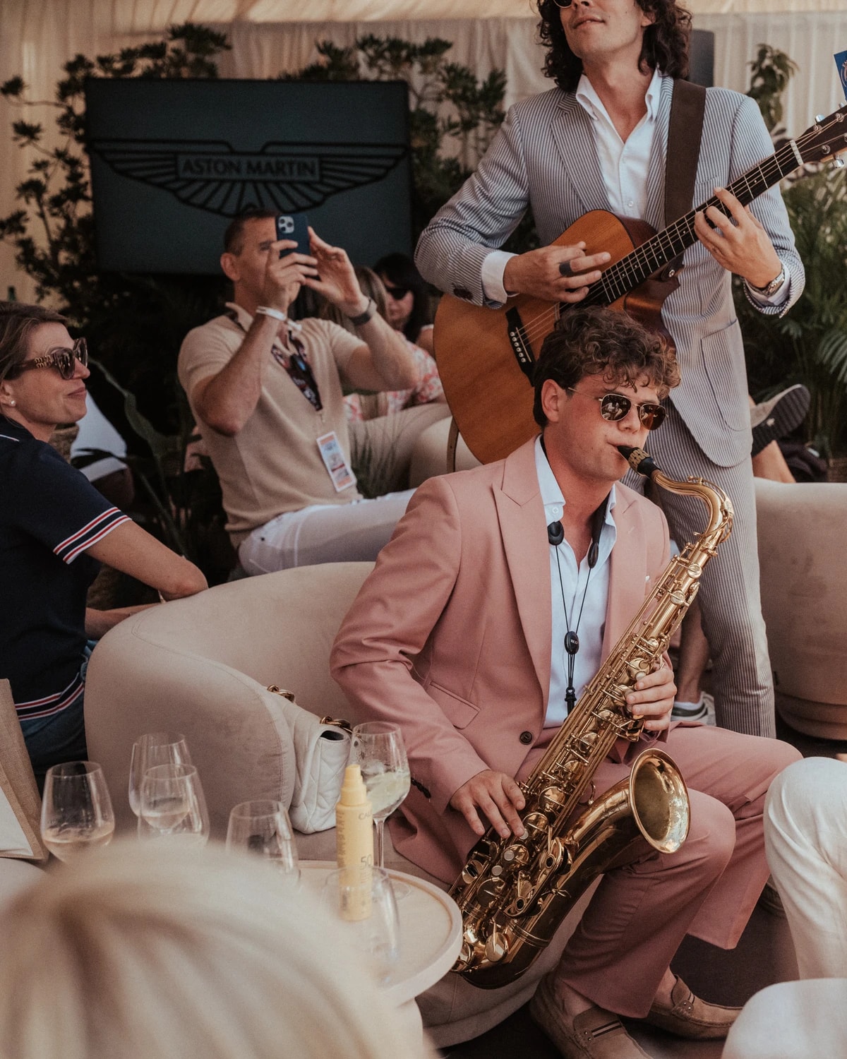 Empire performing for guests beside the Aston Martin marque at a corporate event